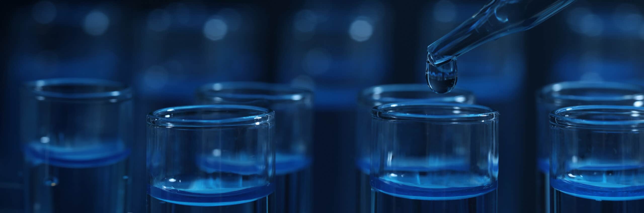 dripping-reagent-into-test-tube-with-blue-liquid-on-dark-background-closeup-laboratory-analysis-2